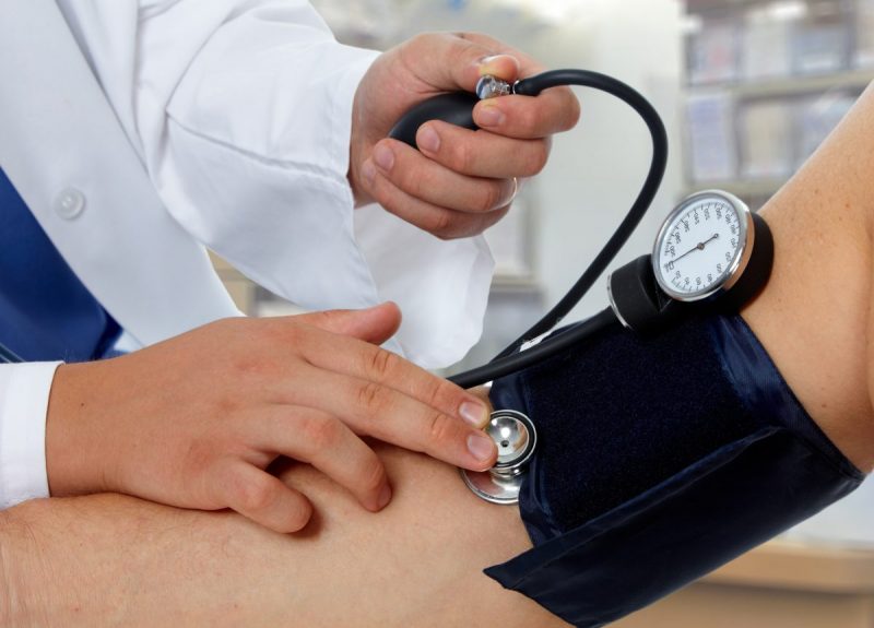 Doctor checking blood pressure. Health care background